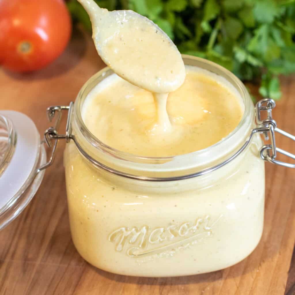 an open jar of sauce with a spoon in it.