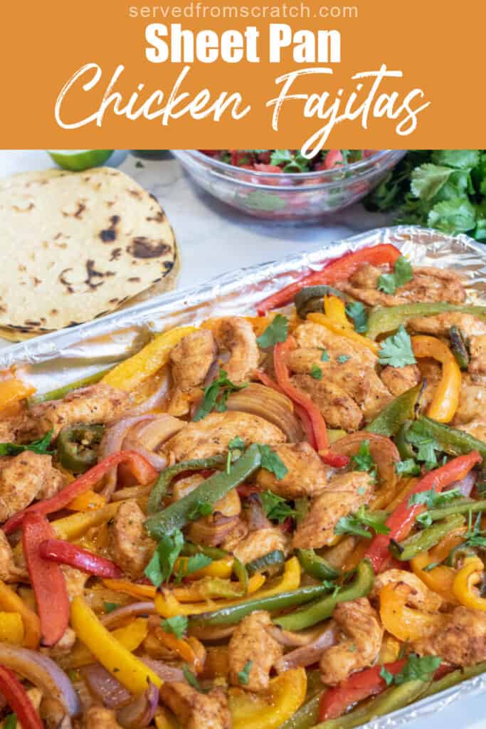 a sheet pan of chicken fajitas, corn tortillas, pico, and cheese with Pinterest pin text.