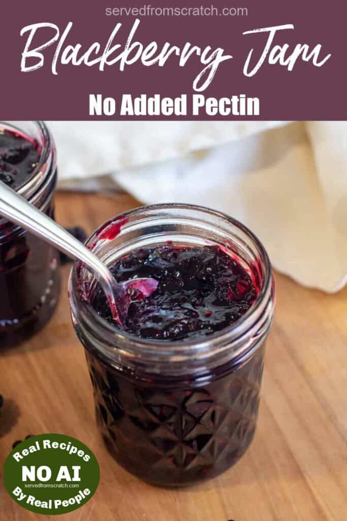 a jar of open blackberry jam with a spoon of jam with Pinterest pin text with NO AI sticker.