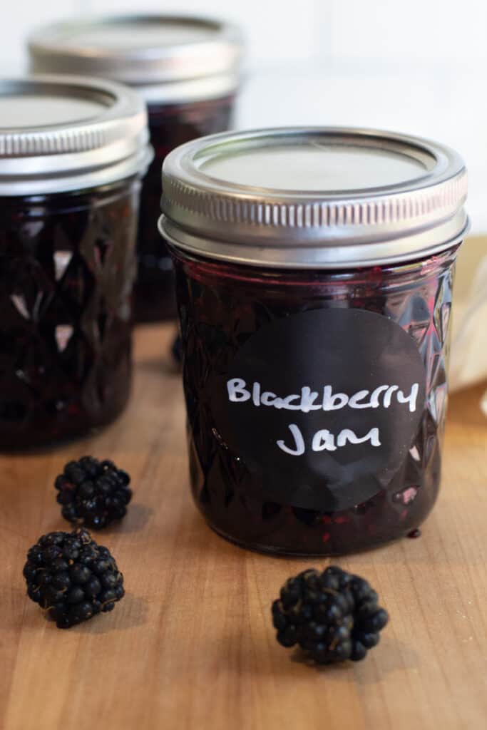 a couple of jars of labeled blackberry jam.