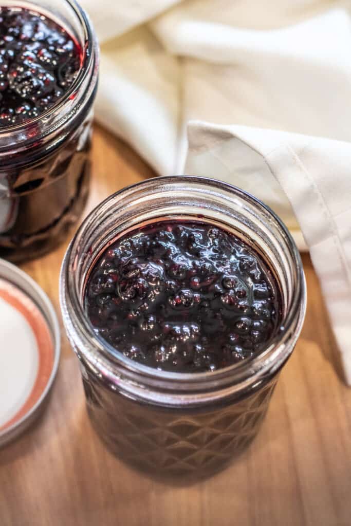 an open jar of blackberry jam.