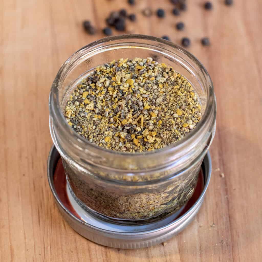 an open jar of lemon pepper seasoning.