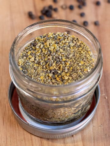 an open jar of lemon pepper seasoning.