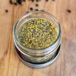 an open jar of lemon pepper seasoning.