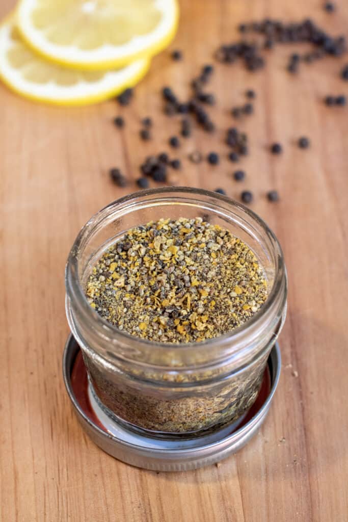 an open jar of lemon pepper seasoning.