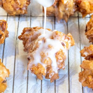 a spoon pouring glaze on a fritter.