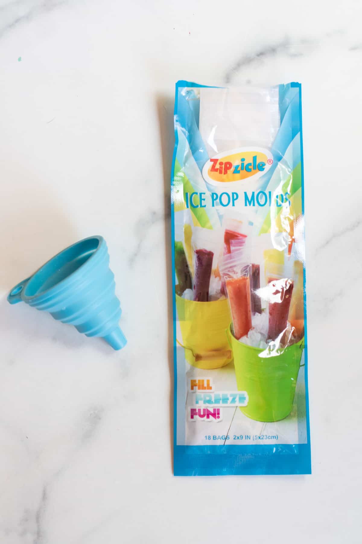 package of freezer pops and a blue funnel. 