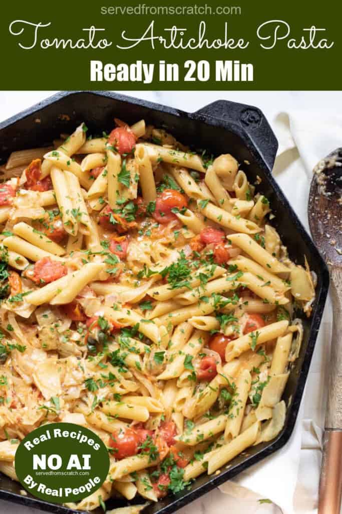 a cast iron of penne pasta with tomatoes and artichokes and parsley with Pinterest pin text and a NO AI sticker.