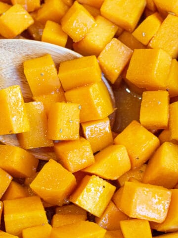 a spoon of butternut squash cooked and cubed.