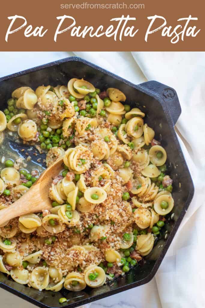 a cast iron with a wooden spoon scooping pasta with peas and pancetta with Pinterest pin text.