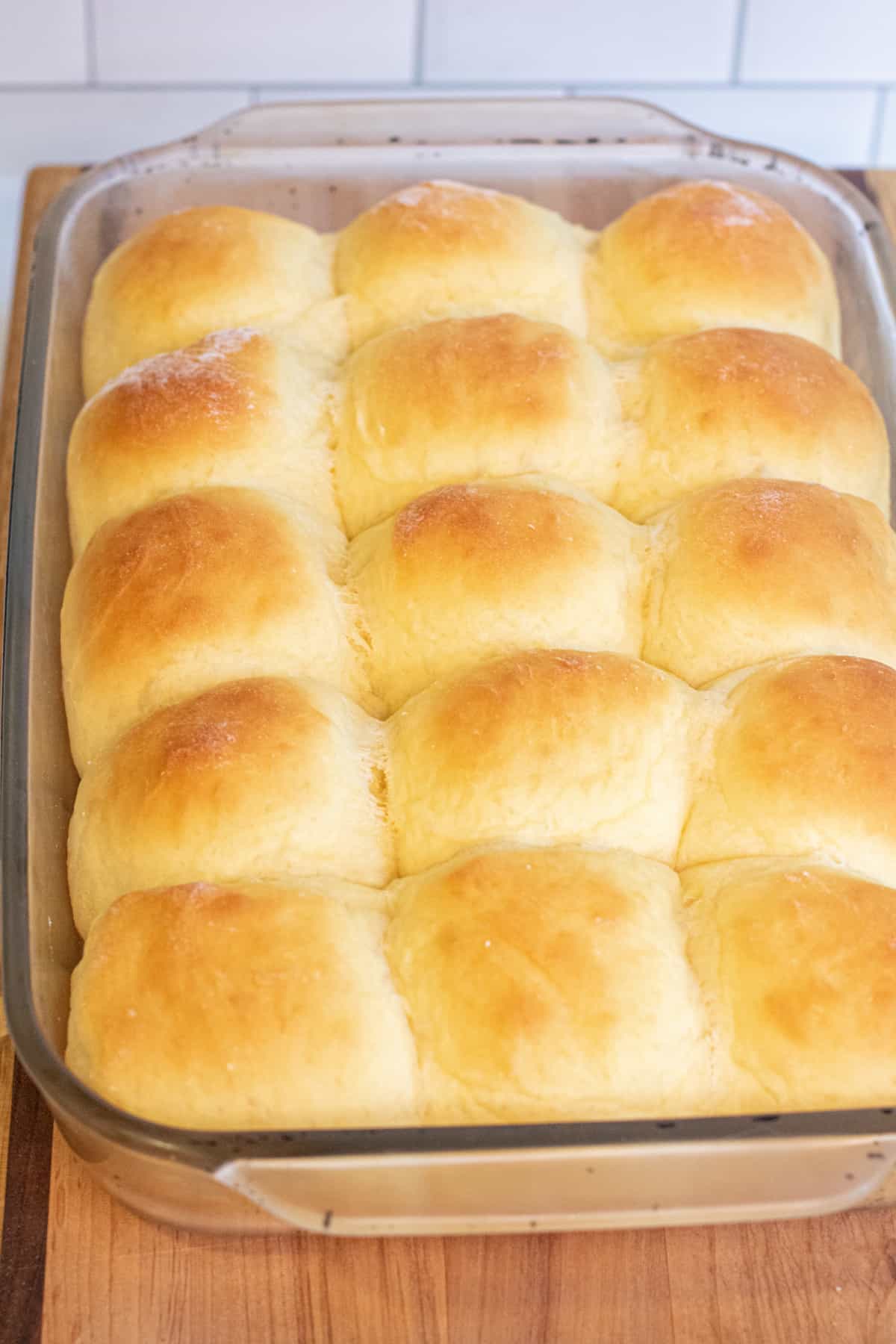 a tray of fluffy baked Hawaiian rolls.