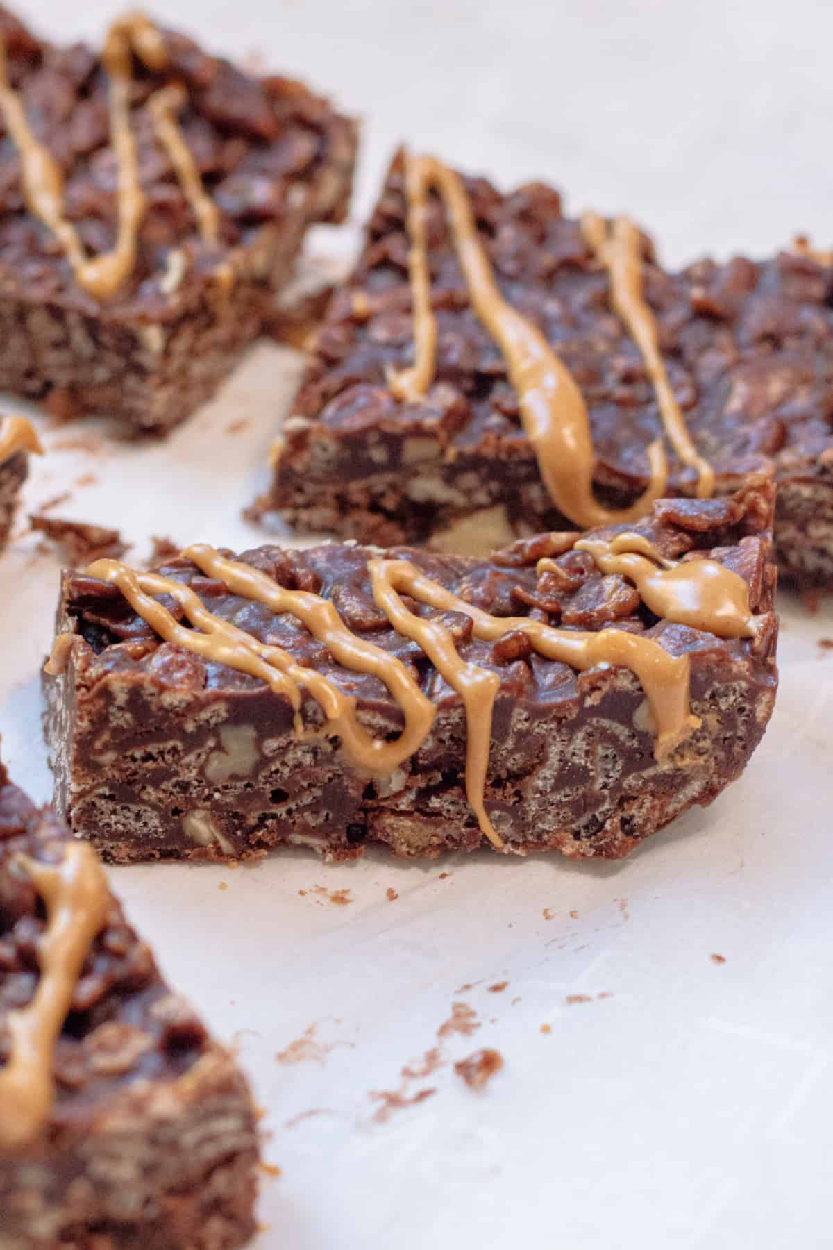 pieces of chocolate crunch bars with peanut butter on top.