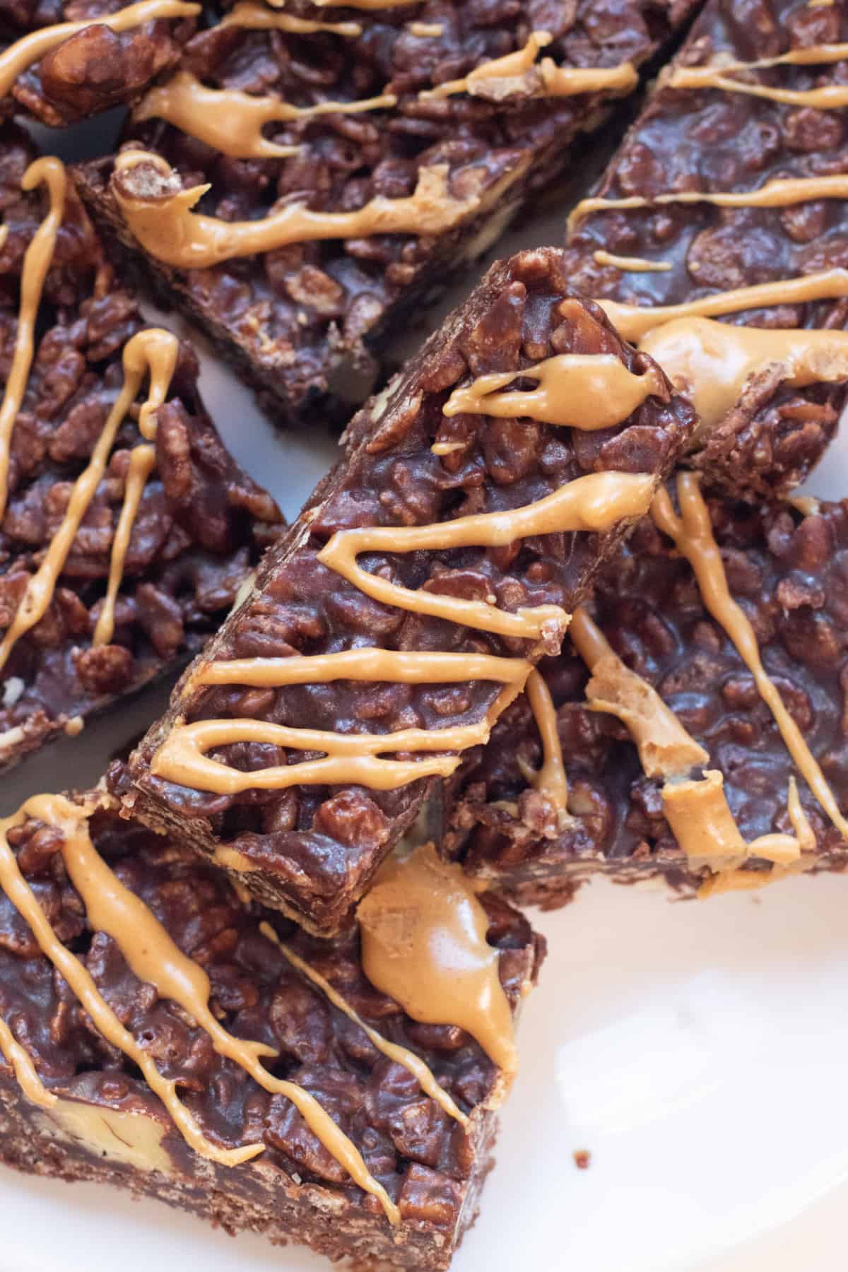a plate of chocolate crunch bars with peanut butter swirls.