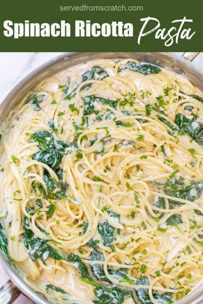 a pan with spaghetti with cream sauce and spinach with Pinterest pin text.