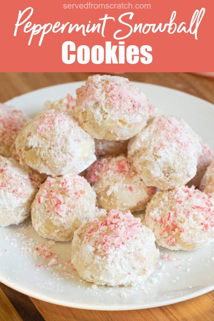 a plate of stacked snowball cookies with crushed candy cane on top with Pinterest pin text.