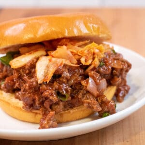 a close up of a sloppy joe with kimchi.