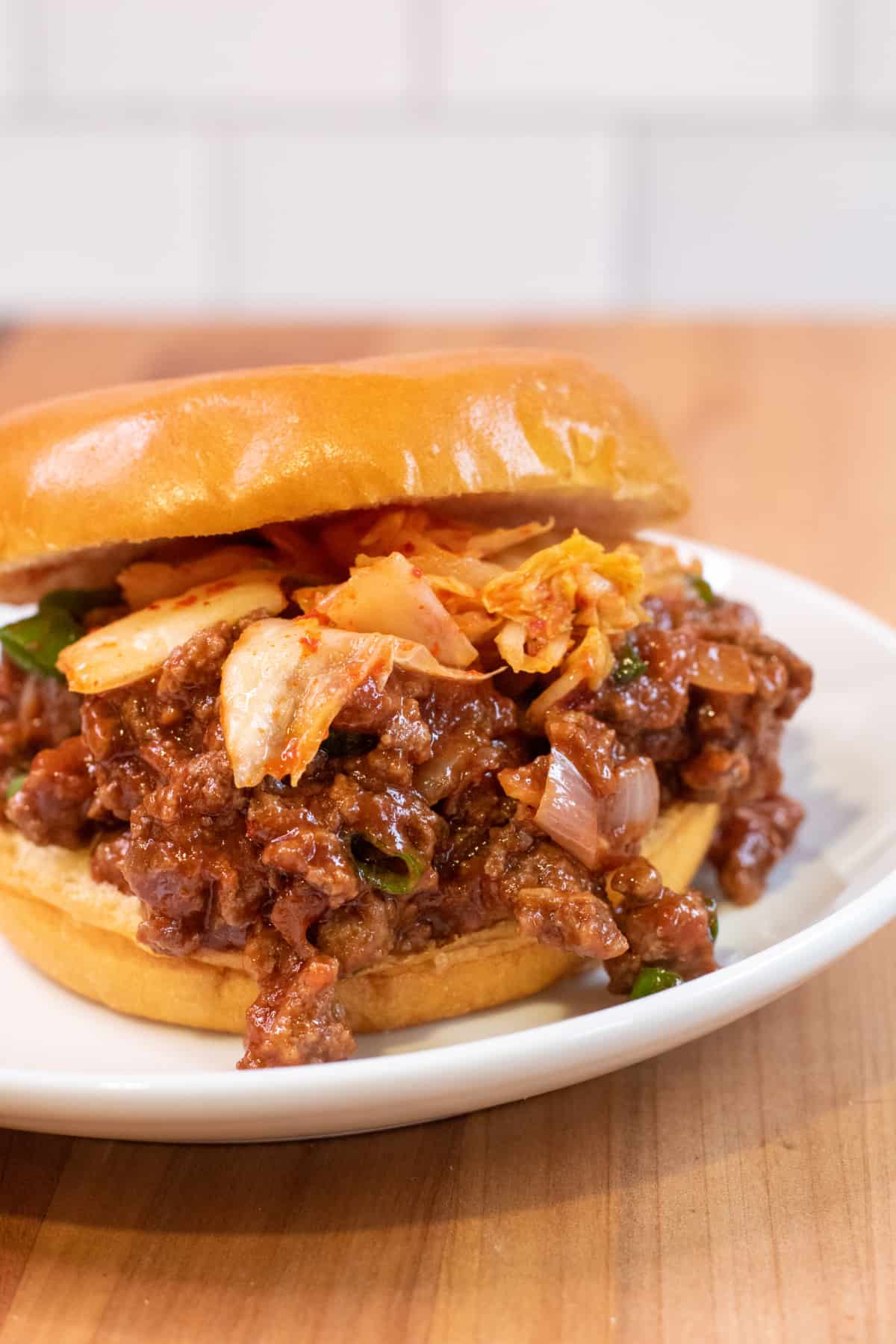 a close up of a sloppy joe with kimchi.