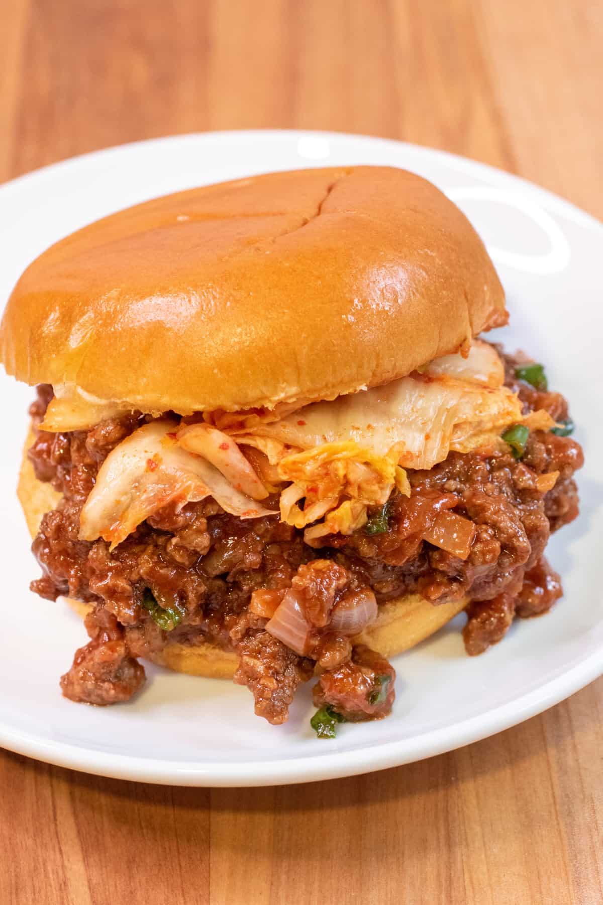 a close up of a sloppy joe with kimchi.