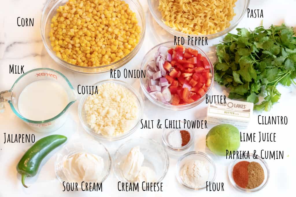 corn, pasta, cilantro, red pepper, cheese, jalapeno, lime, spices, sour cream, cream cheese, and onion.