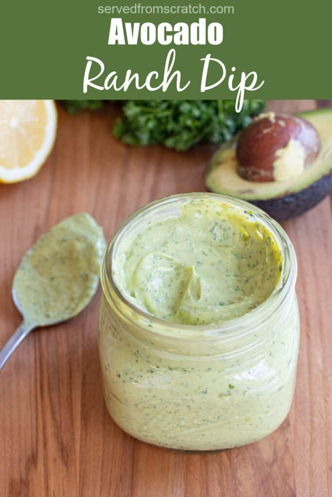 an open mason jar of a green creamy dressing with Pinterest pin text.