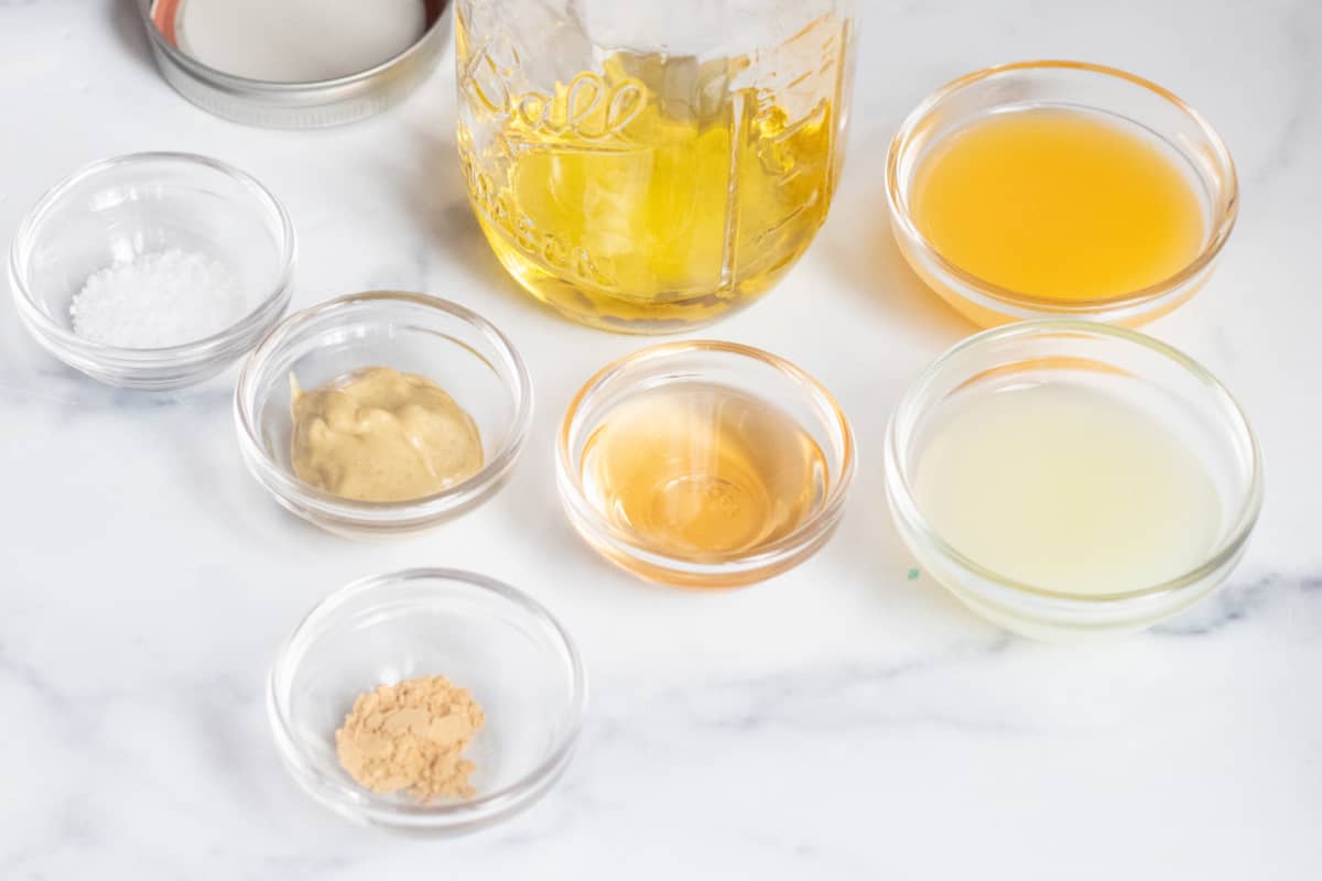 a mason jar with small bowls of ingredients around it.