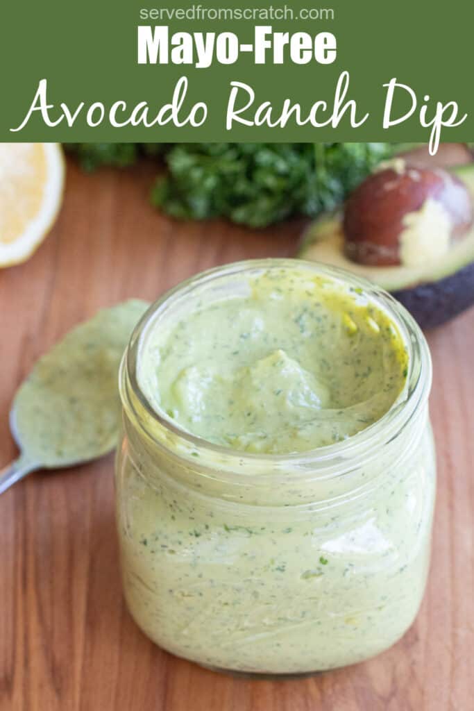 an open mason jar of a green creamy dressing with Pinterest pin text.