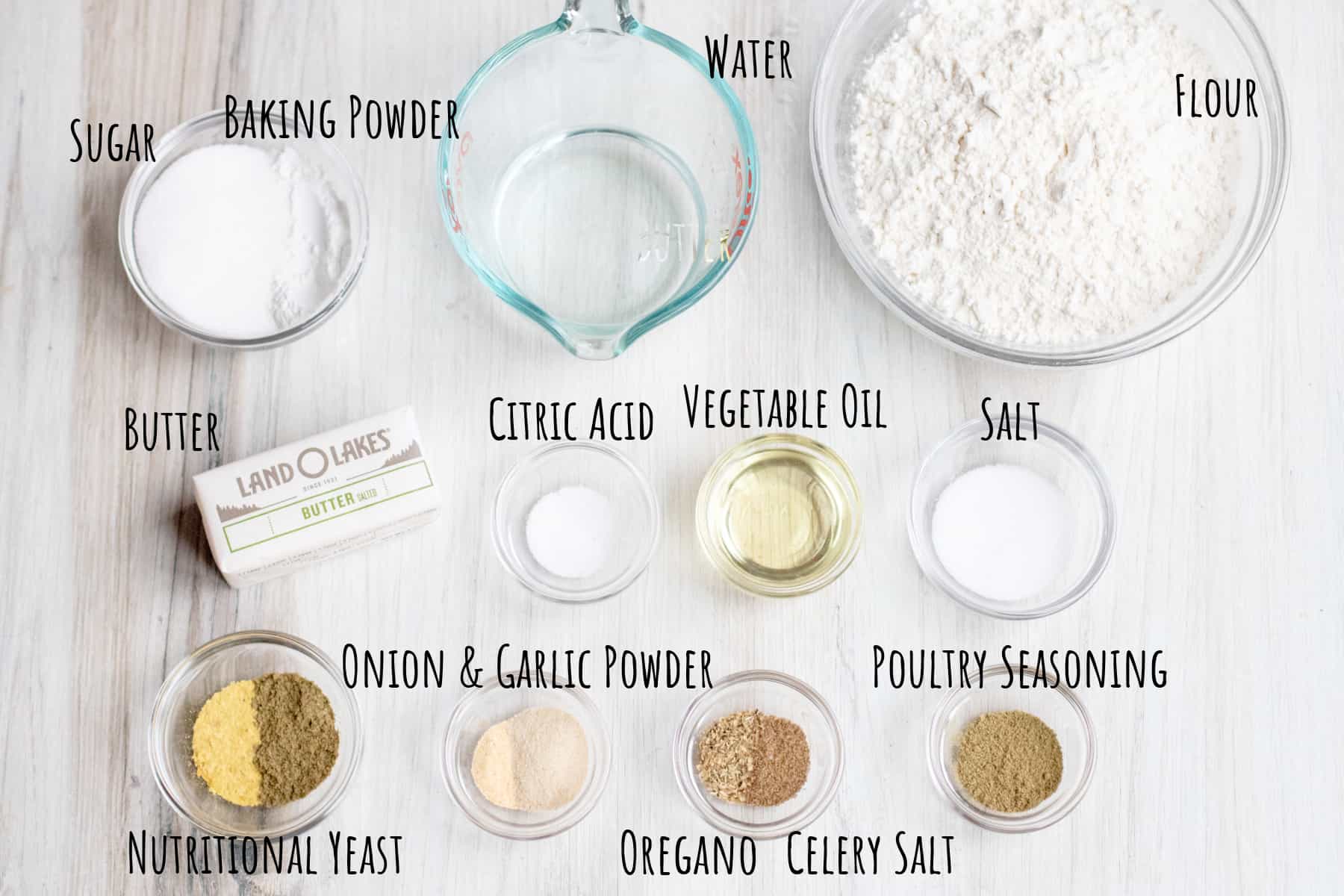 a bowl of flour, water, sugar, spices, oil, butter on a counter.