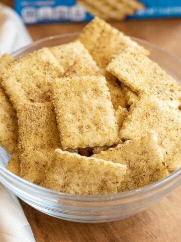 a bowl of crackers in front of a blue box.