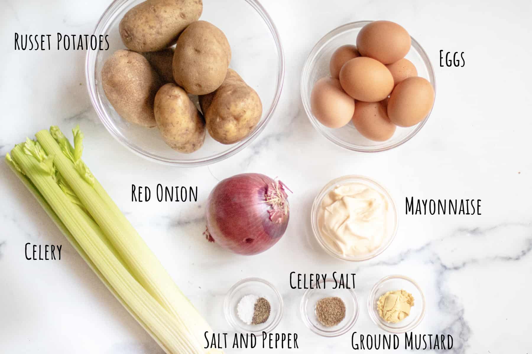 a bowl of potatoes, eggs, celery, onions, mayo, and spices.