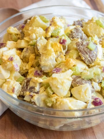 a large bowl of creamy potato salad with eggs.