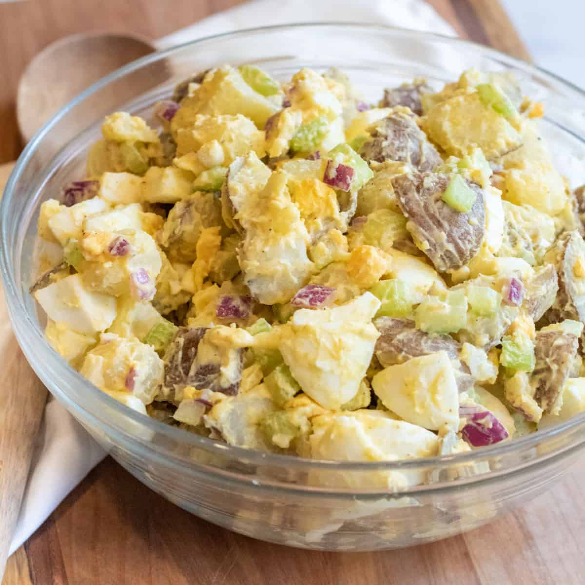 a large bowl of creamy potato salad with eggs.