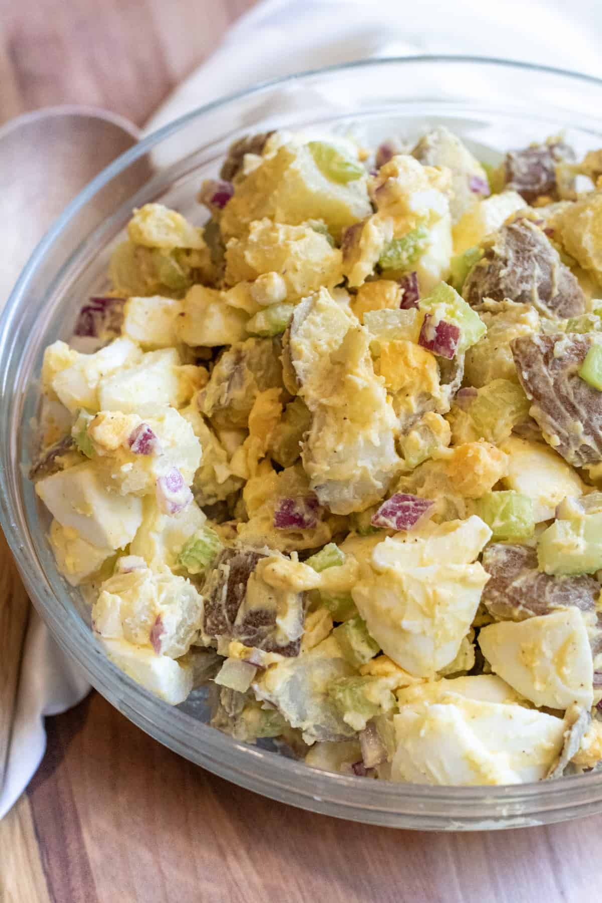 a large bowl of creamy potato salad with eggs.