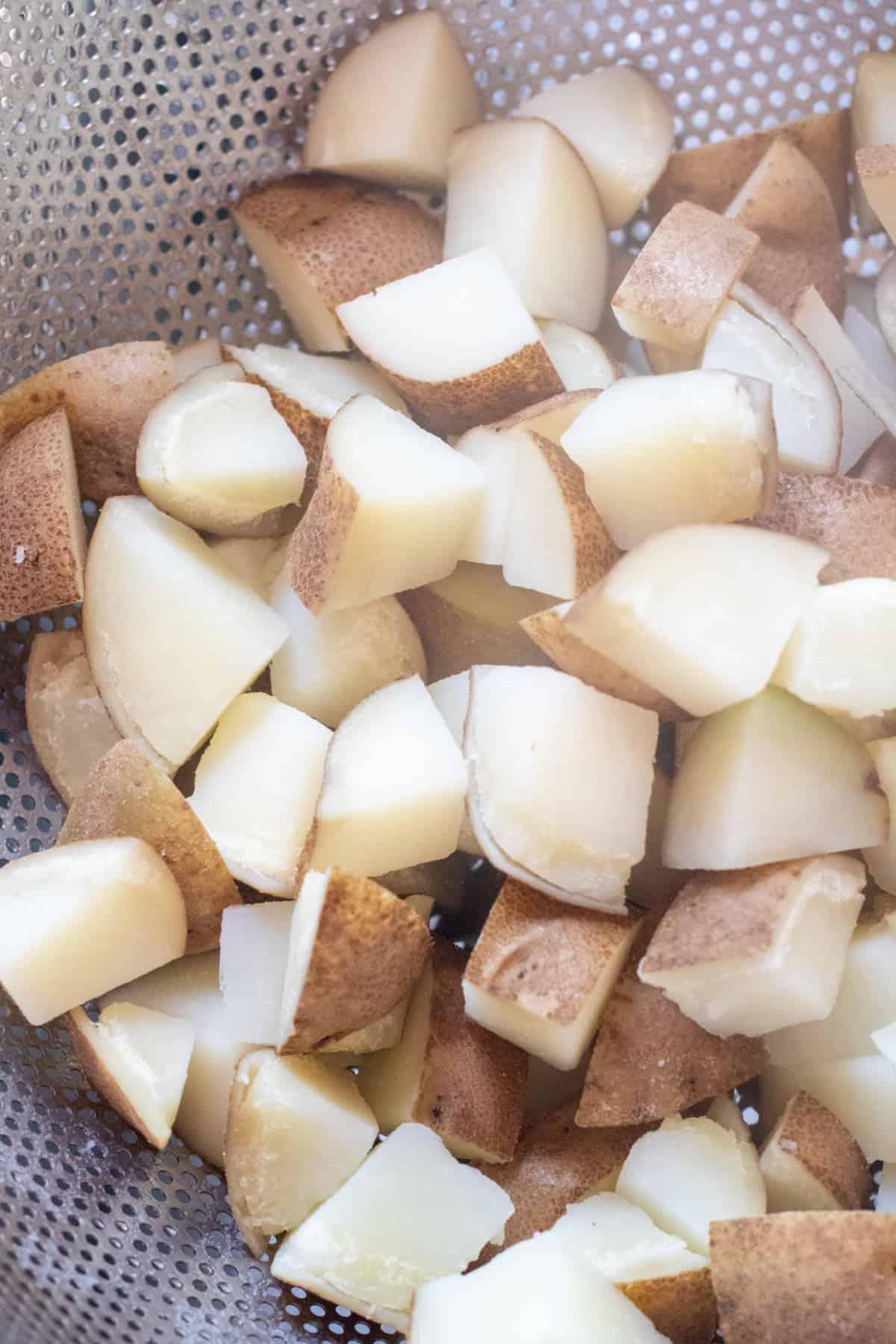 boiled potatoes in a colander.