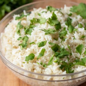 a bowl of rice topped with chopped cilantro.