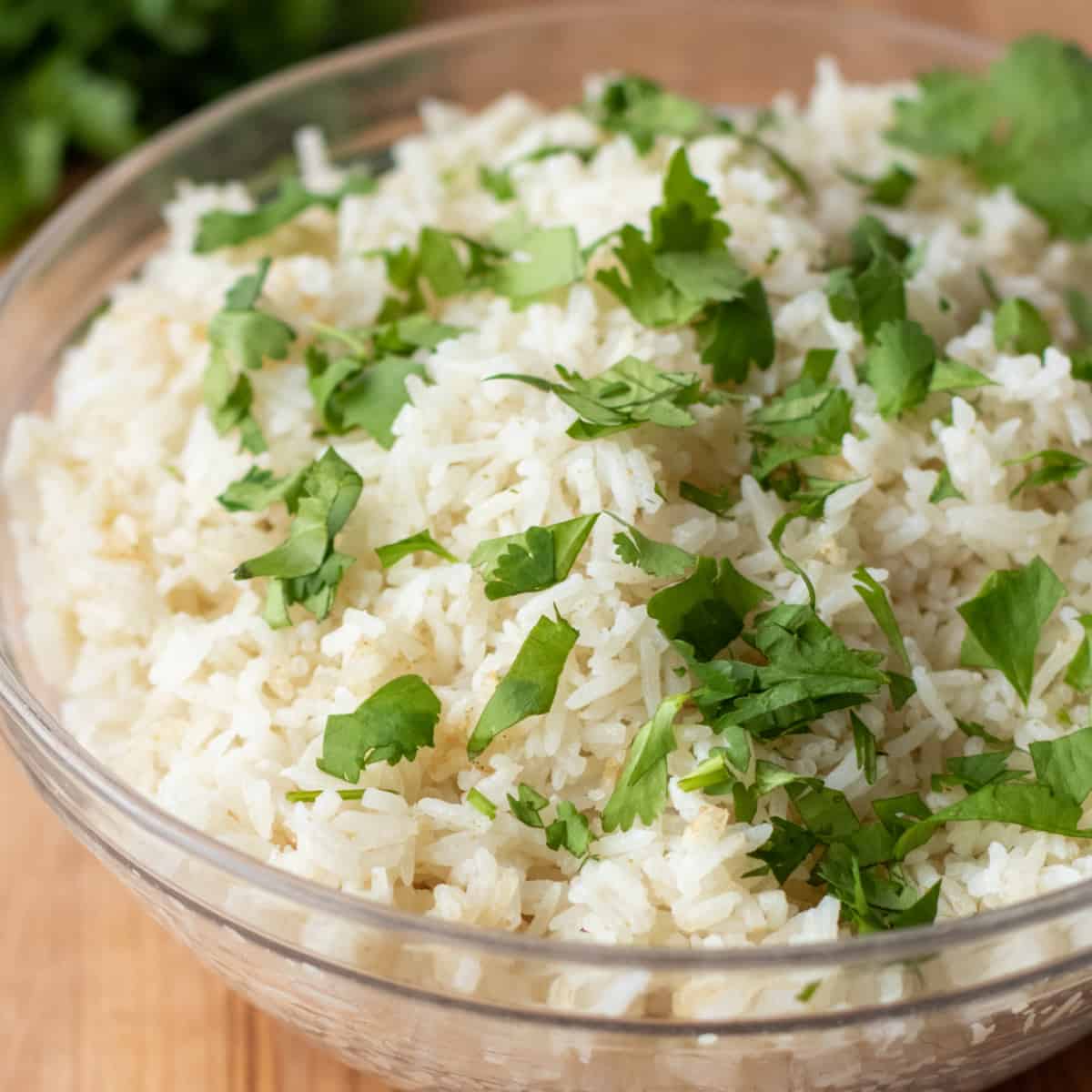 a bowl of white rice with chopped cilantro on top. 