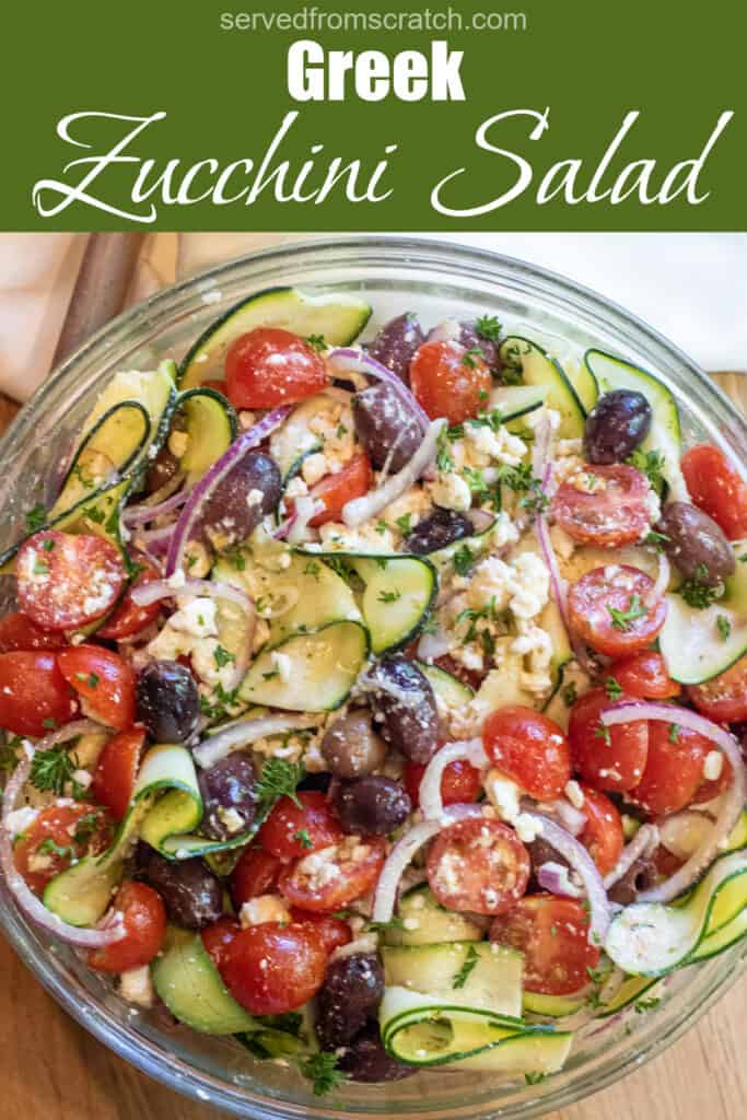 a bowl of zucchini salad with tomatoes, olives, onions and feta with Pinterest pin text.