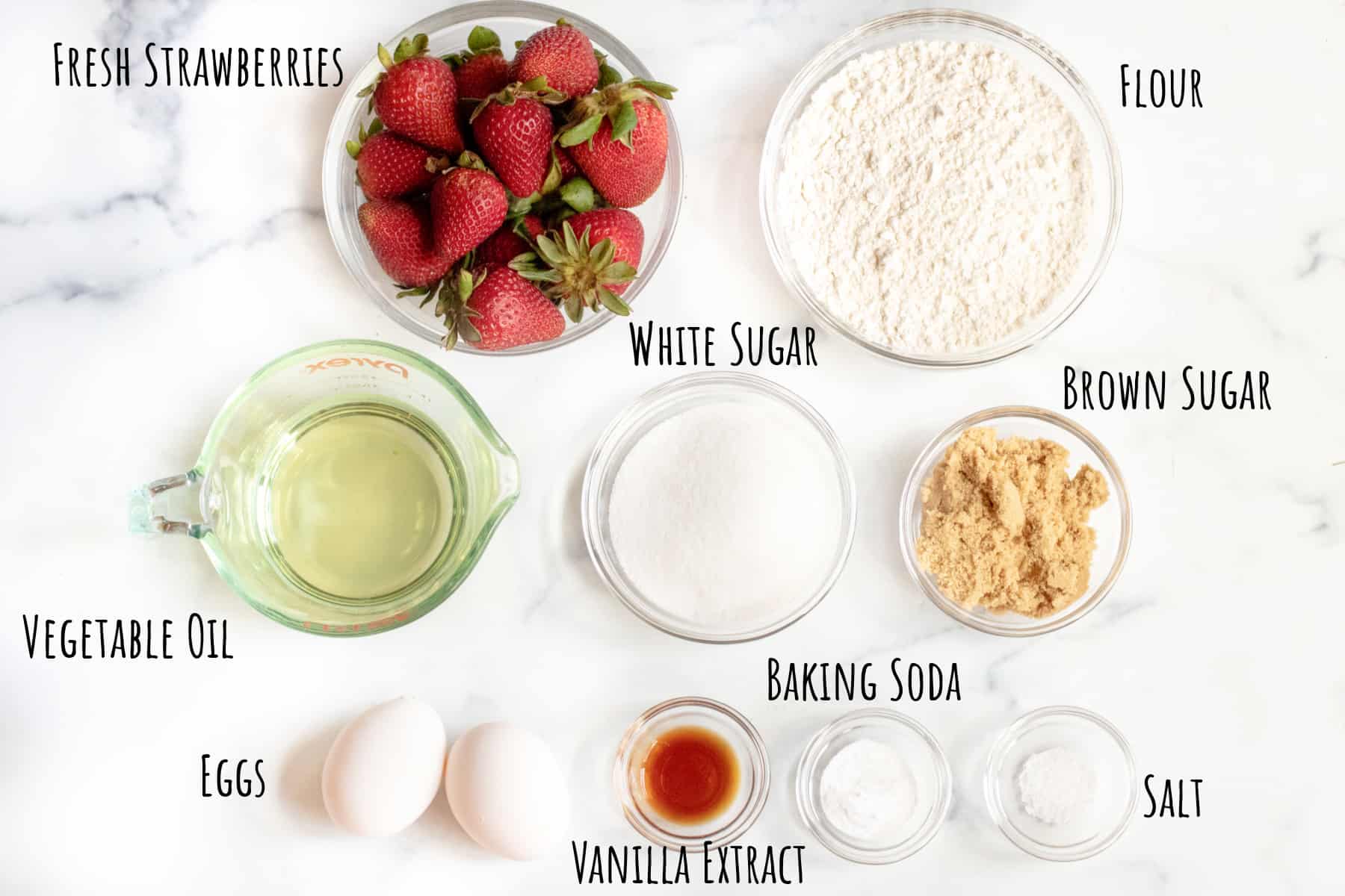 strawberries, flour, oil, sugars, eggs, vanilla, baking soda, and salt in bowls.