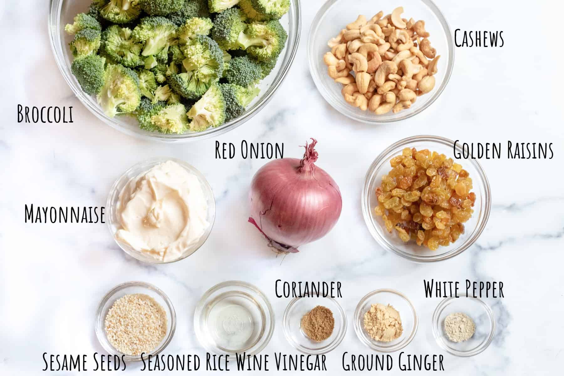 broccoli, cashews, onion, mayo, raisins, sesame seeds, spices, and salt.