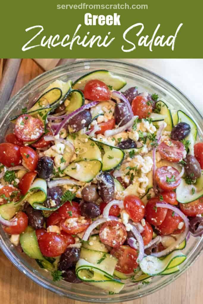 an overhead of a zucchini noodle salad with tomatoes, olives, and feta and onions with Pinterest pin text.
