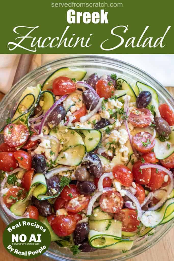 an overhead of a zucchini noodle salad with tomatoes, olives, and feta and onions with Pinterest pin text with NO AI sticker.