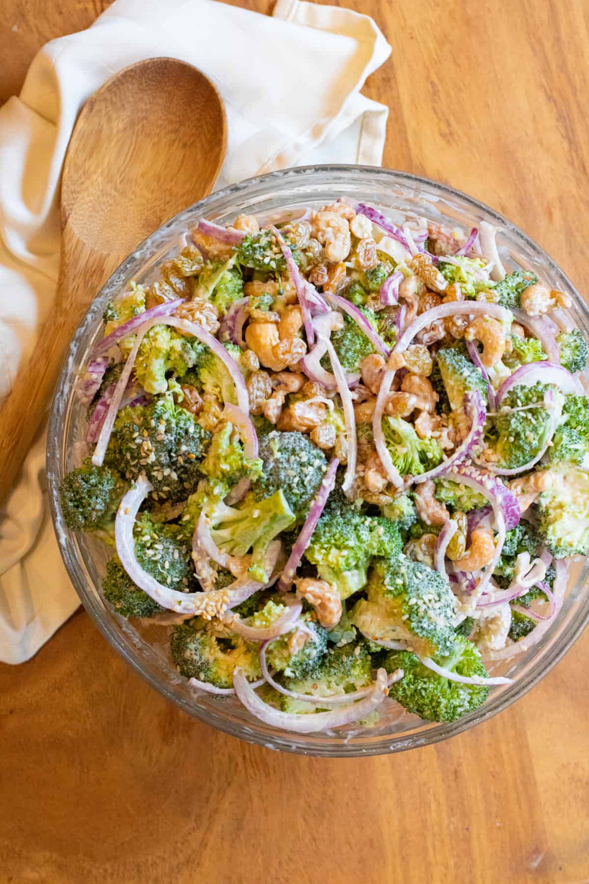 a bowl of broccoli salad with onions.