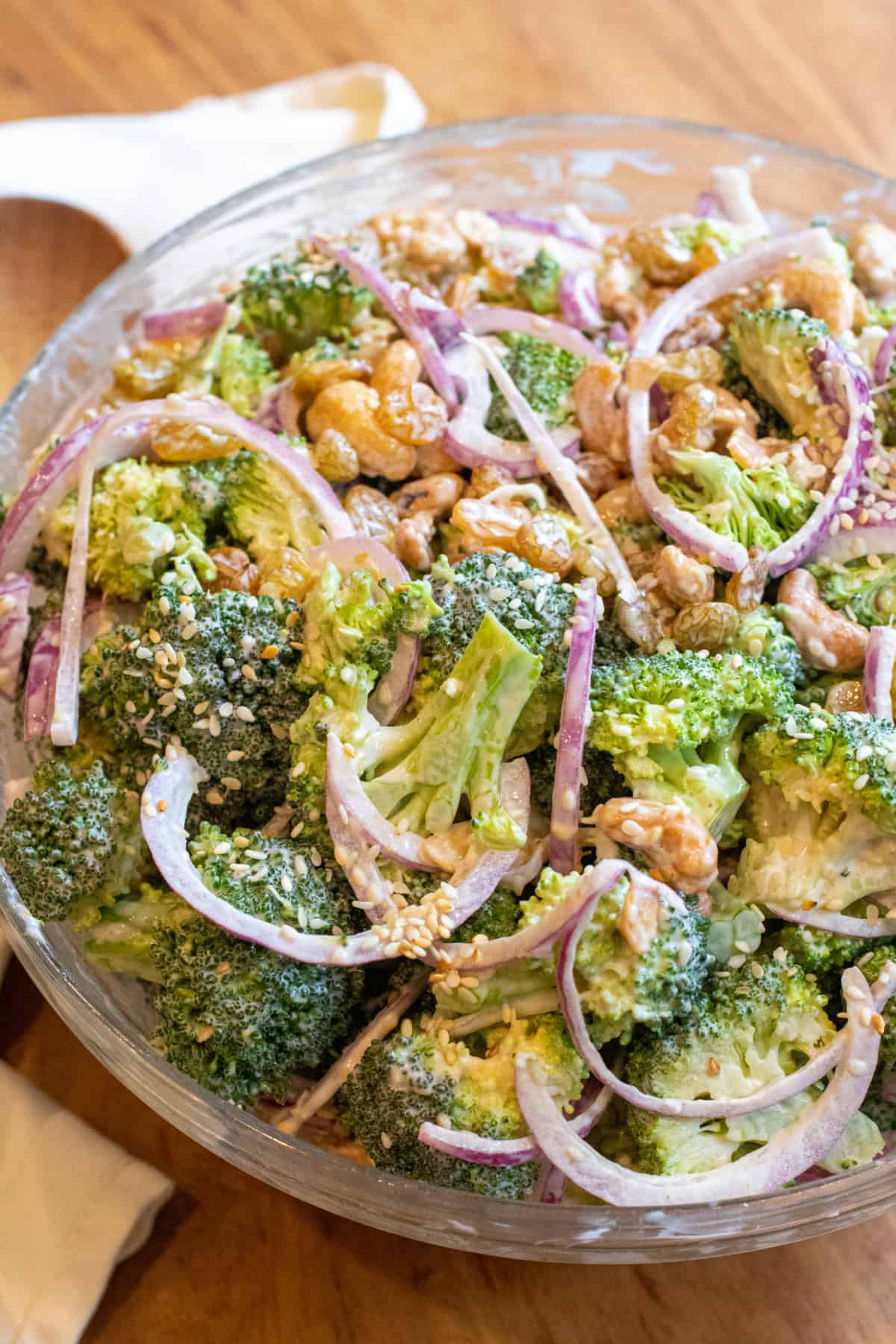 a bowl of broccoli salad with onions.