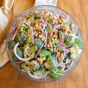 a bowl of broccoli salad with onions.