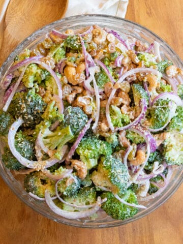 a bowl of broccoli salad with onions.