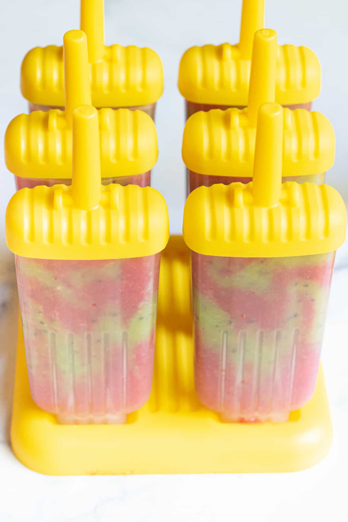 popsicles in yellow popsicle holders.