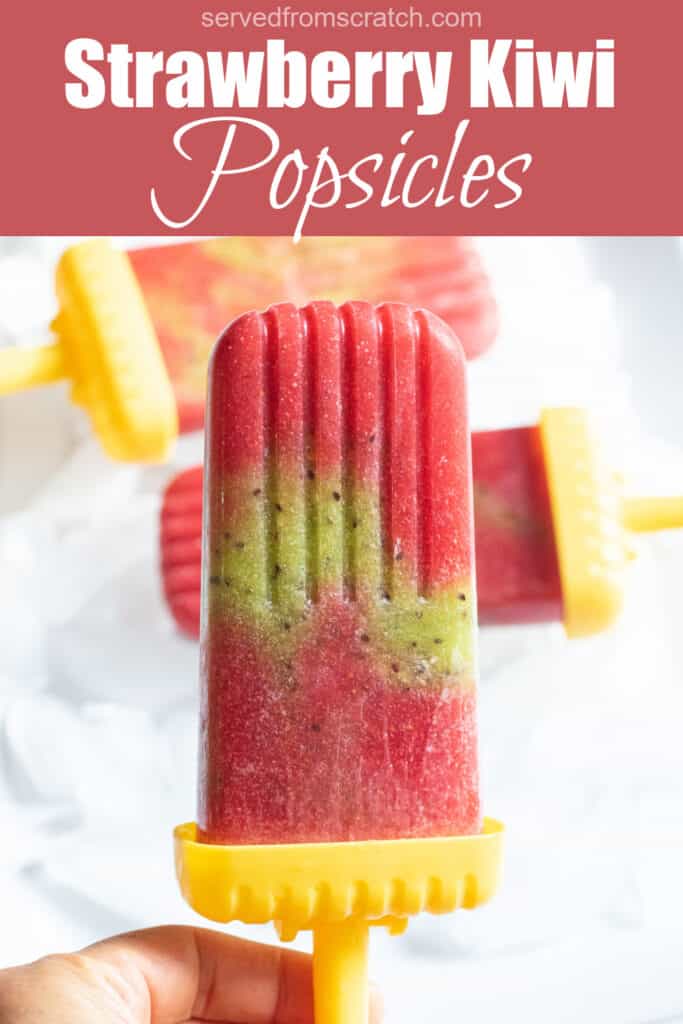 a strawberry and kiwi popsicle held by a hand with Pinterest pin text.