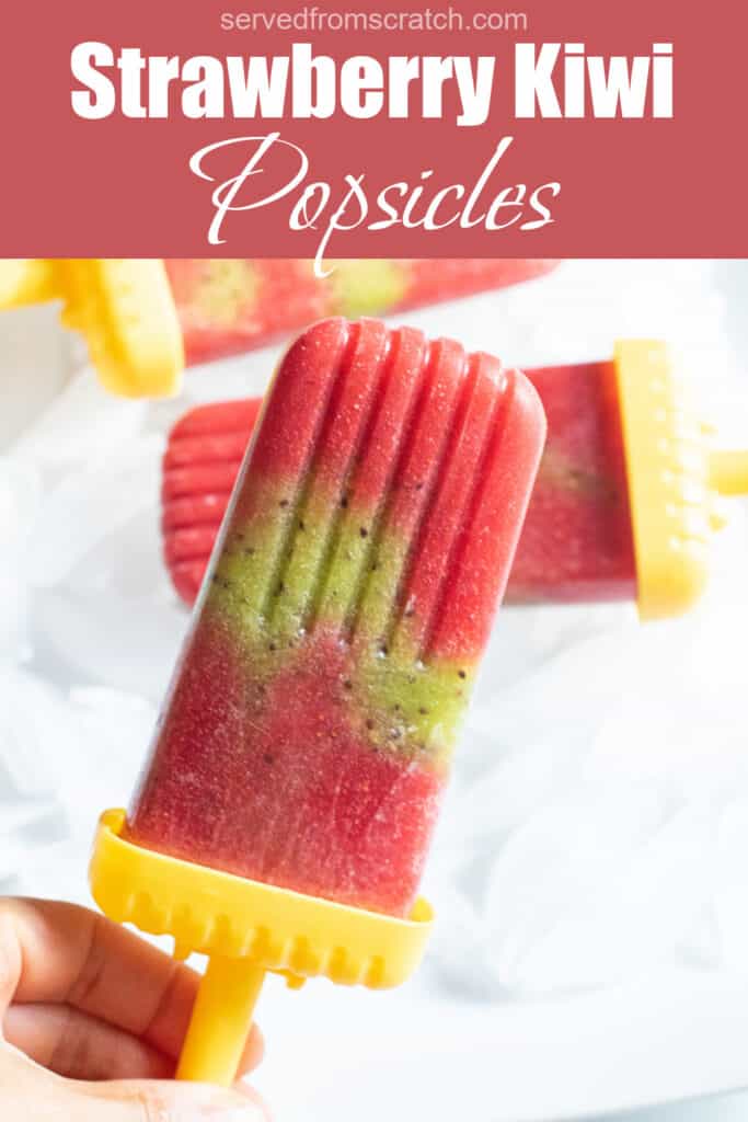 a strawberry and kiwi popsicle held by a hand with Pinterest pin text.