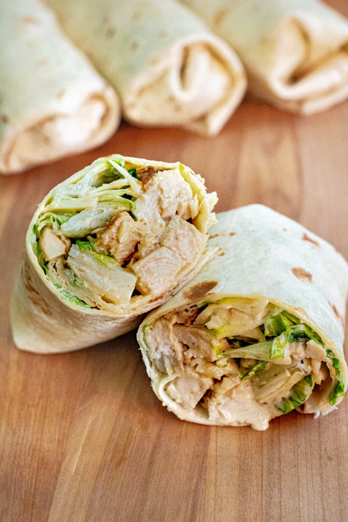 a wrap halved with chicken and lettuce.