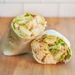 a wrap halved with chicken and lettuce.