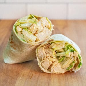 a wrap halved with chicken and lettuce.